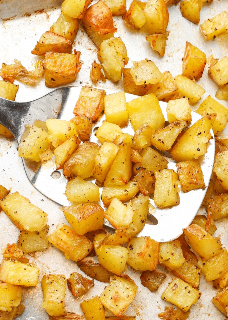 Sheet pan and spatula with potatoes