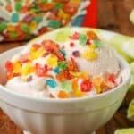 Close-up of Fruity Pebbles Ice Cream, topped with Fruity Pebbles cereal, served in a small white bowl