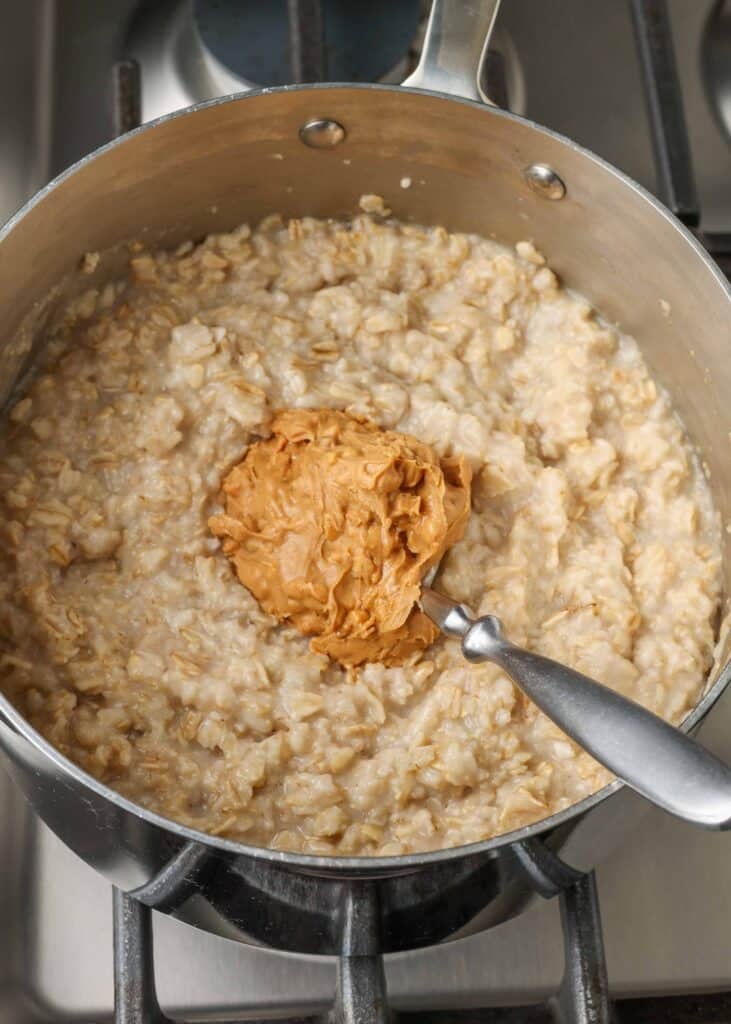 oatmeal in pan with a scoop of peanut butter