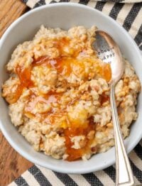 peanut butter oatmeal with apricot jam drizzled over it