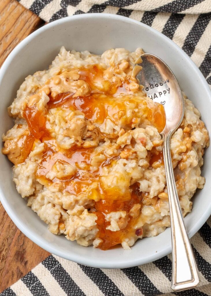 peanut butter oatmeal with apricot jam drizzled over it