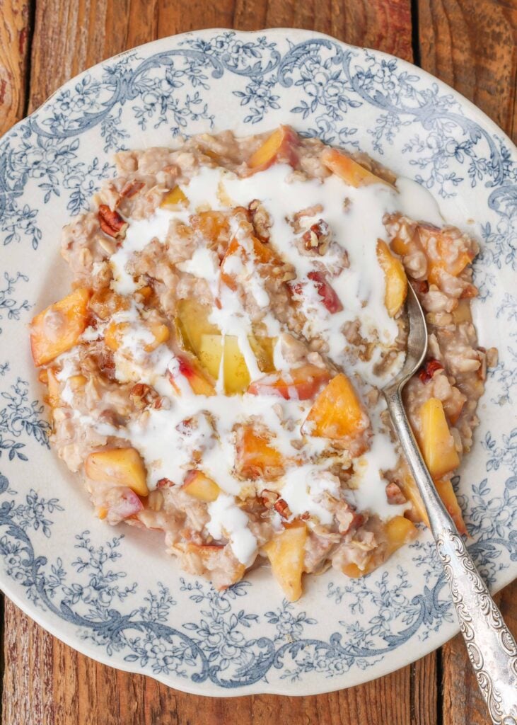 peach oatmeal topped with a drizzle of cream