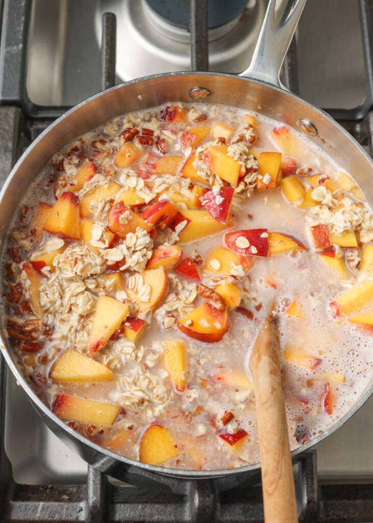 peach oatmeal in pan on stove, whence to cook
