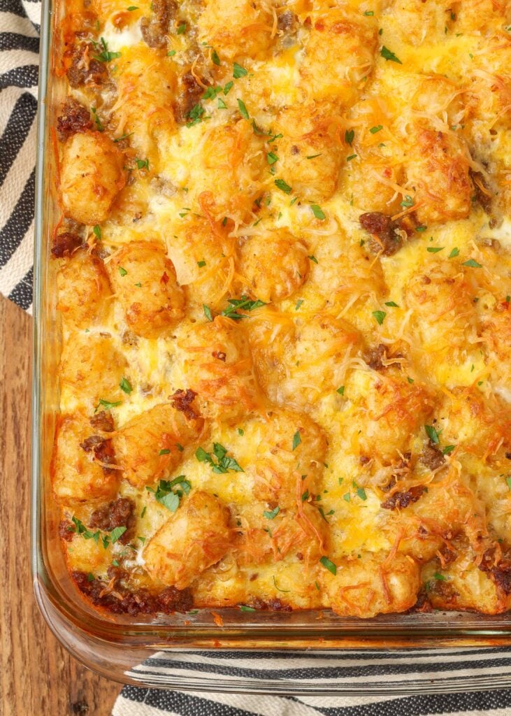 The tater tot breakfast casserole has come out of the oven and is crispy brown on the whet with gooey melted cheese on top.