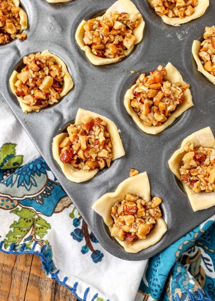 puff pastry in muffin tin filled with nuts and honey