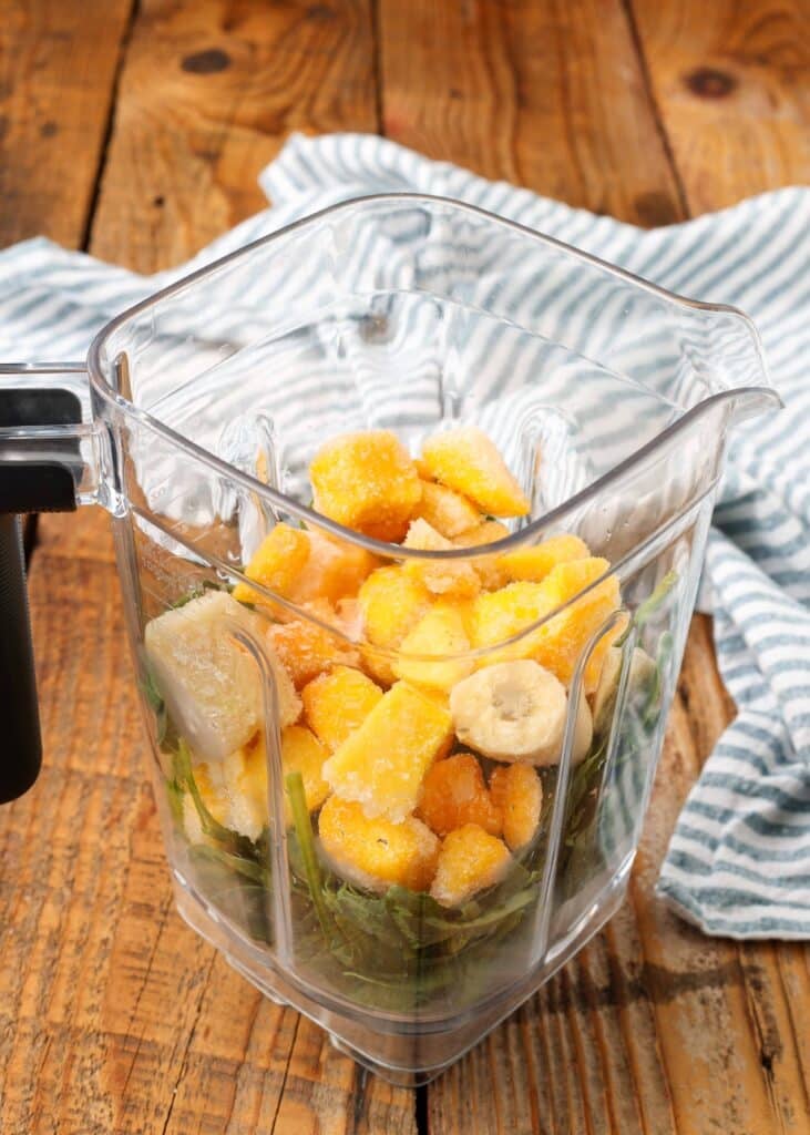 mango, bananas, and baby spinach in blender