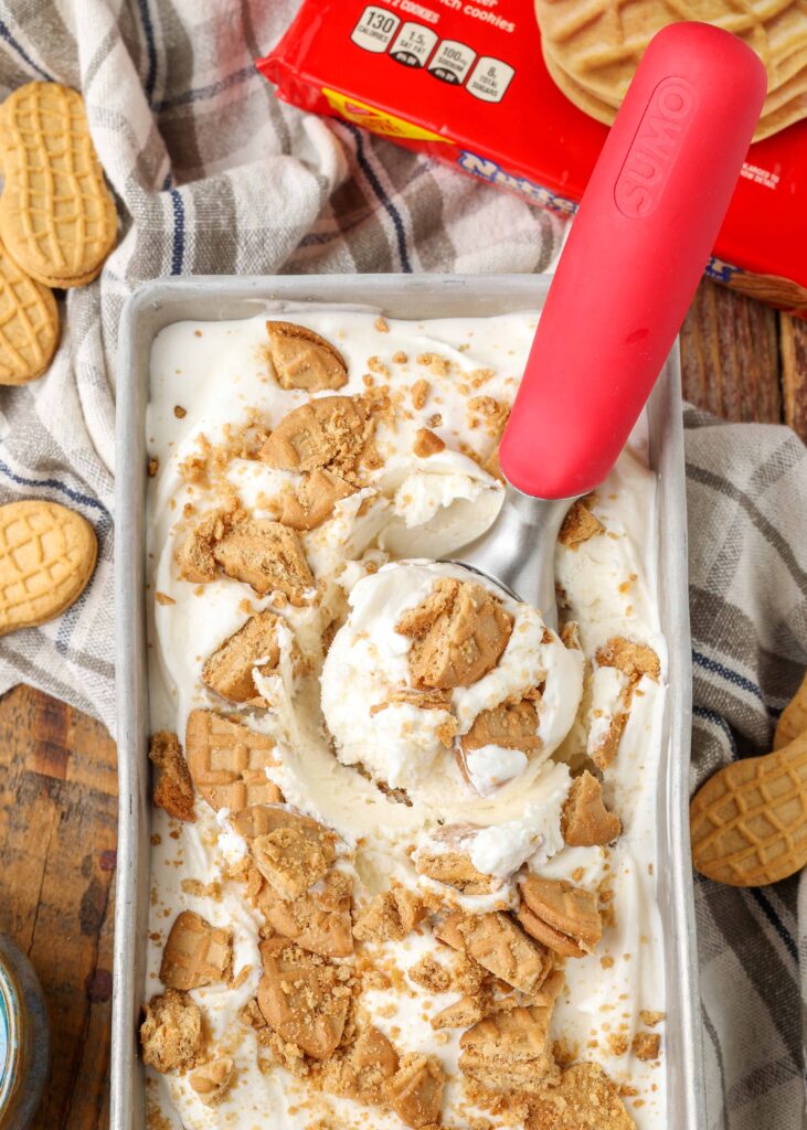 red ice cream scoop holding cookie filled ice cream