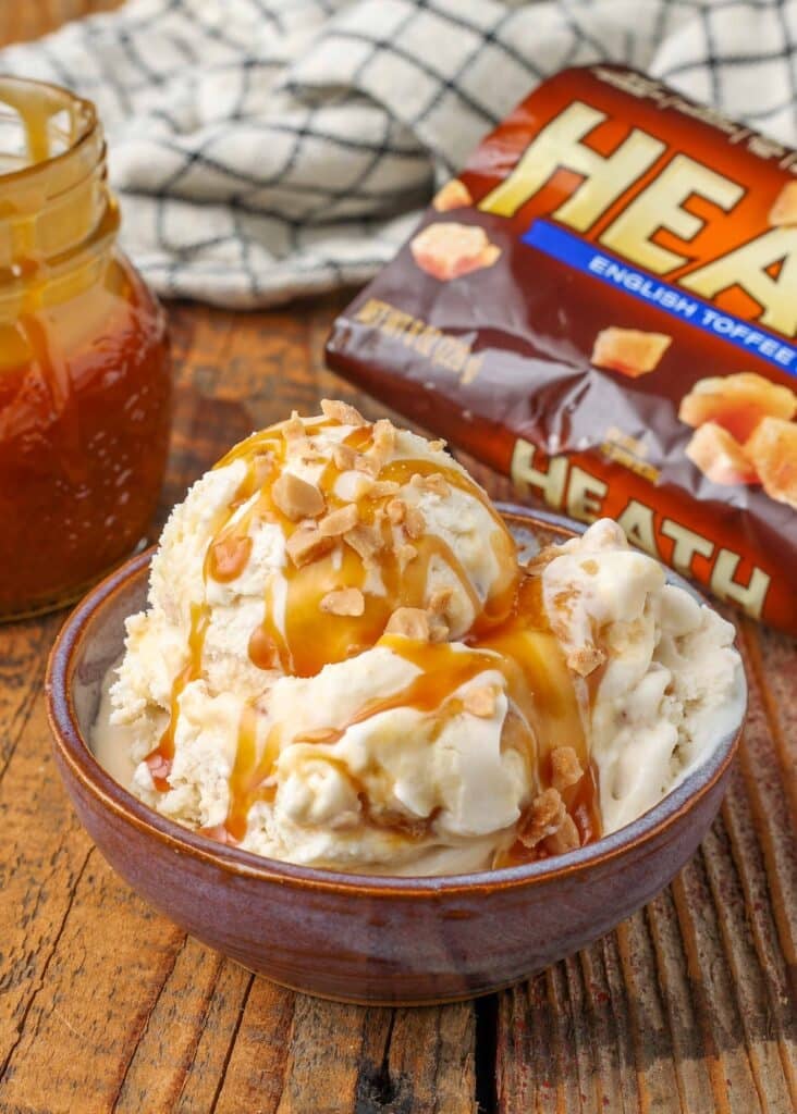 Toffee ice cream topped with toffee bits and caramel sauce
