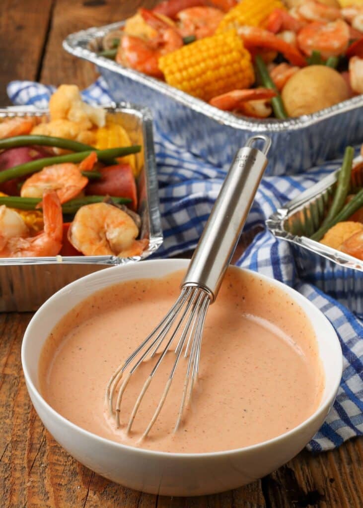 Vertical shot Cajun Dipping Sauce with Shrimp and Vegetables