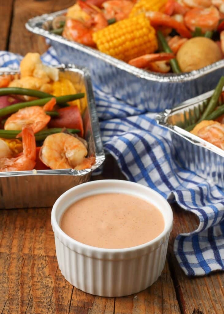 Vertical shot with bowl of Cajun Dipping Sauce and shrimp and vegetables
