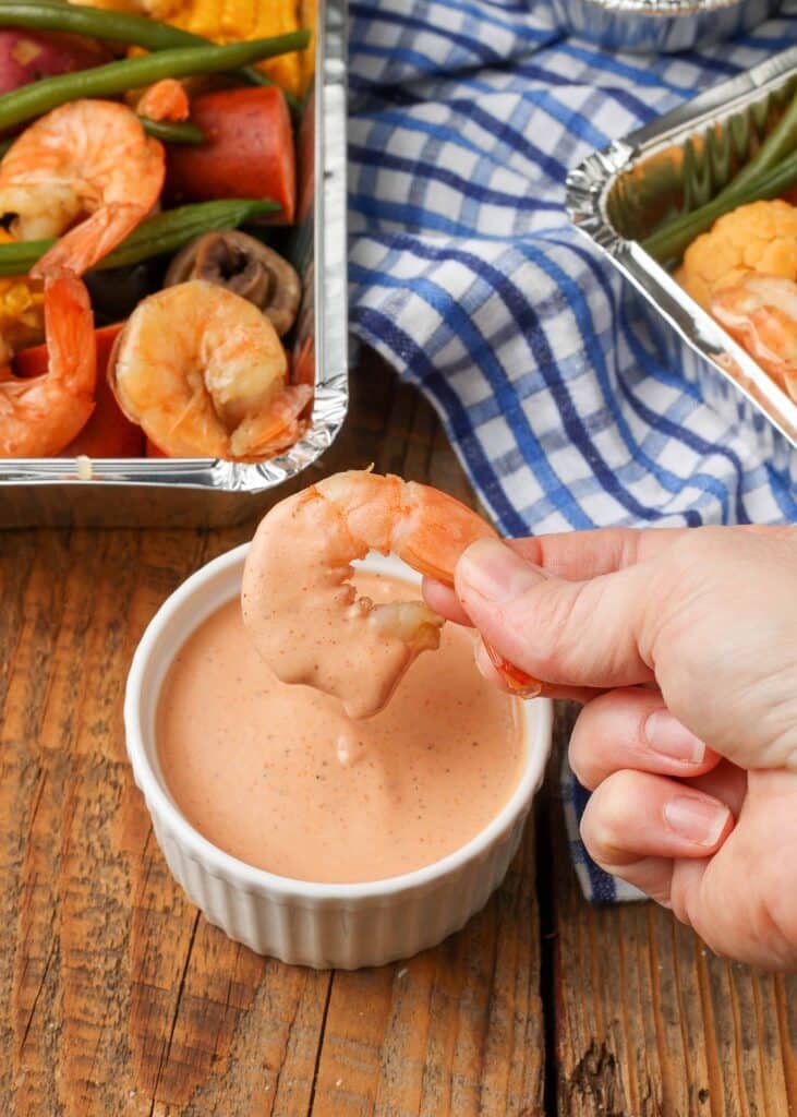 Overhead vertical shot of shrimp dipped in Cajun Dipping Sauce