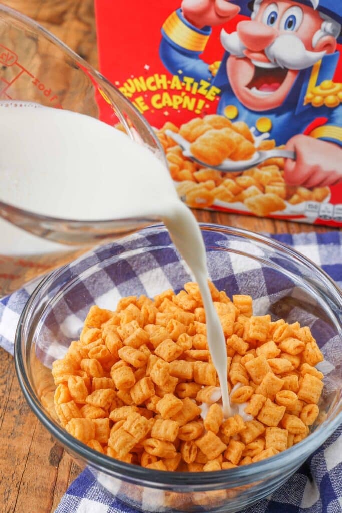 Adding milk to a bowl of Captain Crunch cereal