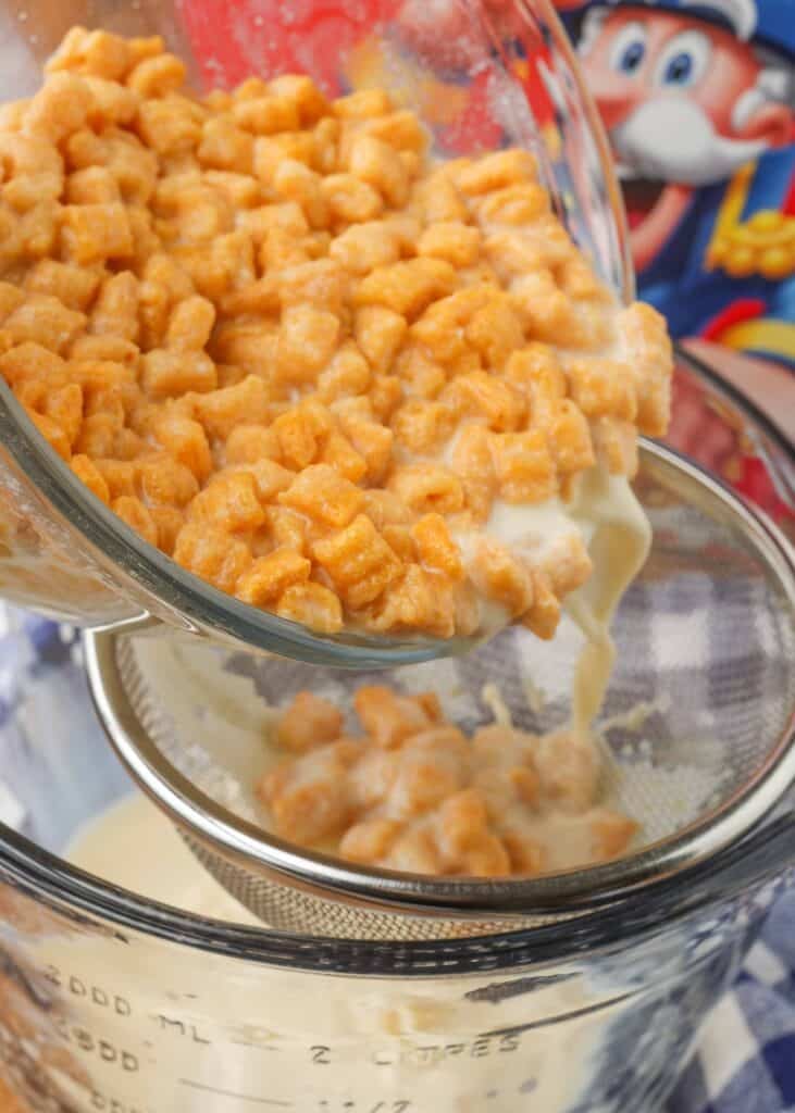 Straining cereal milk from bowl of cereal