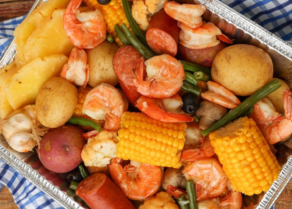 Overhead close-up shot of shrimp boil in silver tray