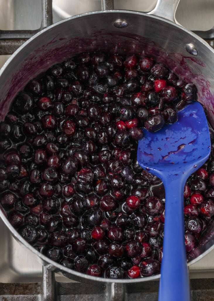 Bursting blueberries in saucepan