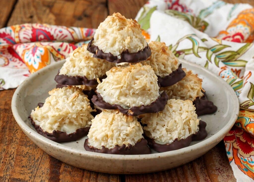 coconut macaroons stacked on plate on wooden table
