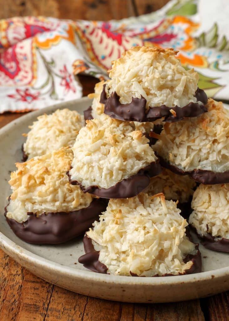 stacked coconut macaroons on plate with linen in background