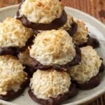 Chocolate Dipped Coconut Macaroons stacked on pottery plate