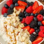 Cottage cheese, berries, and fruit drizzled with honey