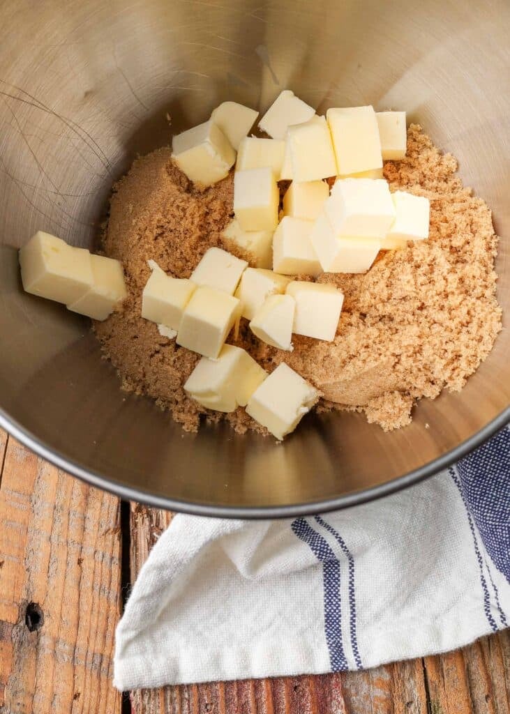 brown sugar and cubed butter for chocolate chip macadamia nut cookies in a mixing bowl