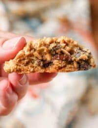 Close-up shot of hand holding gooey peanut butter cookie