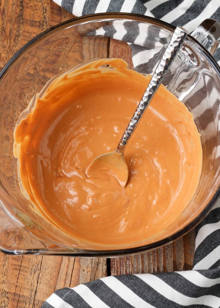 Peanut butter and butterscotch melted together in glass bowl