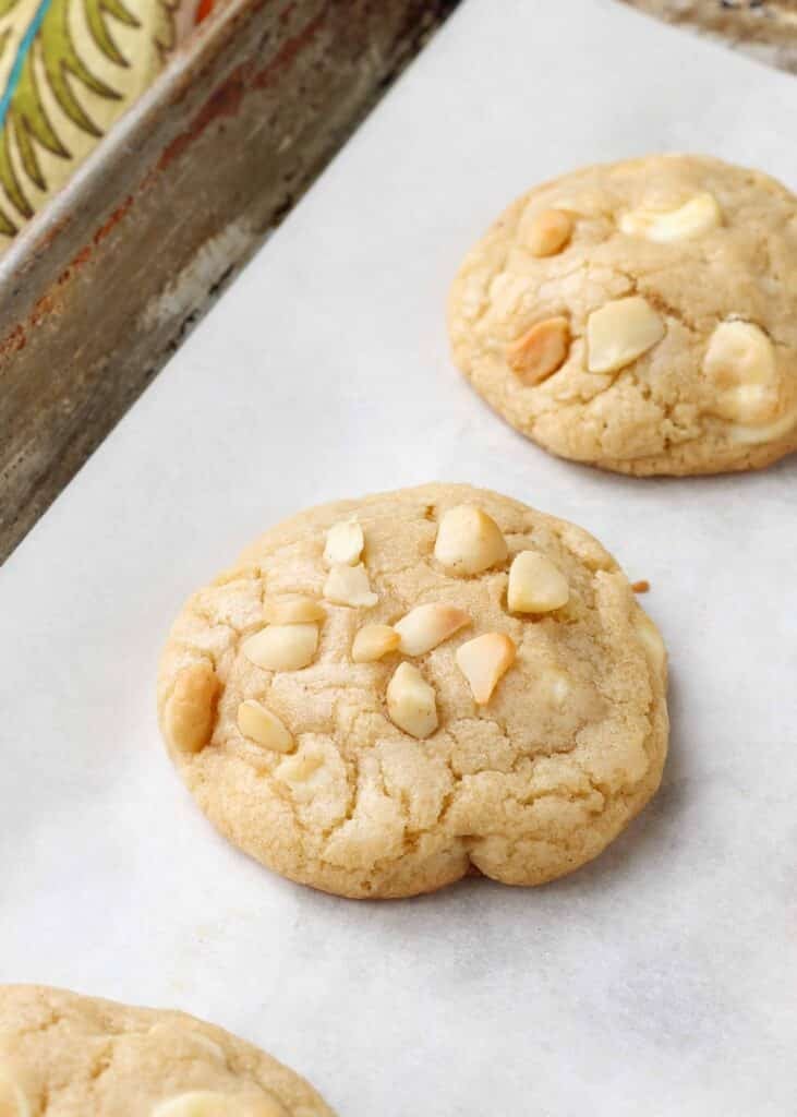 close up of macadamia chocolate chip cookie on parchment