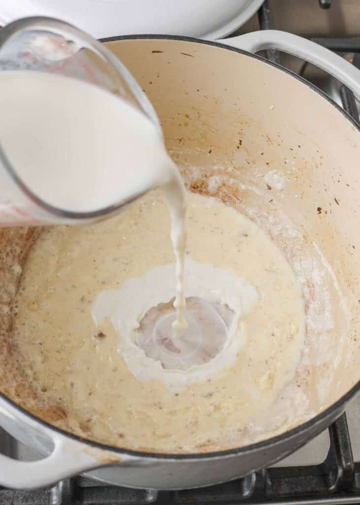 Adding milk to mixture in pot
