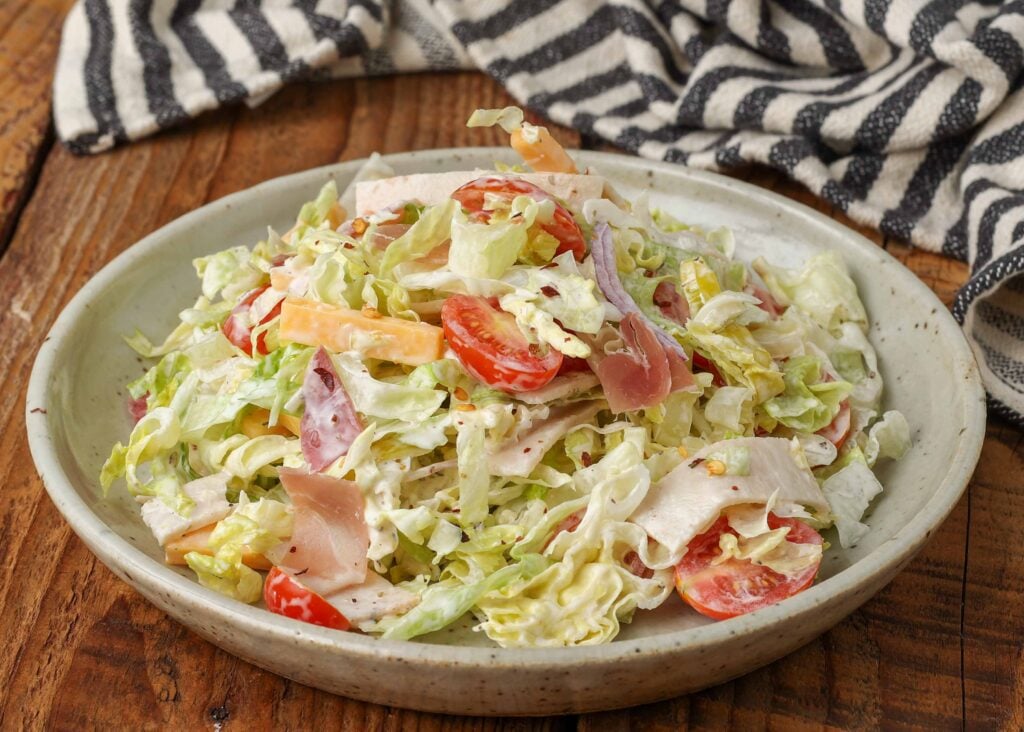 grinder salad with lots of meat, cheese, and plenty of tangy dressing