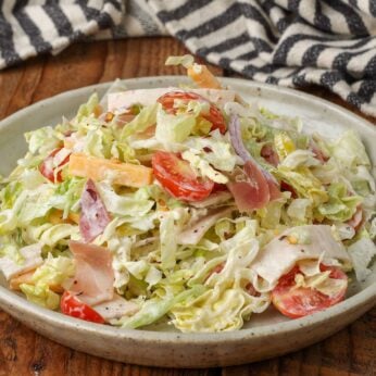 grinder salad with lots of meat, cheese, and plenty of tangy dressing