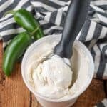 ice cream with scoop in container next to jalapenos