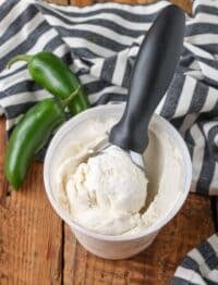 ice cream with scoop in container next to jalapenos
