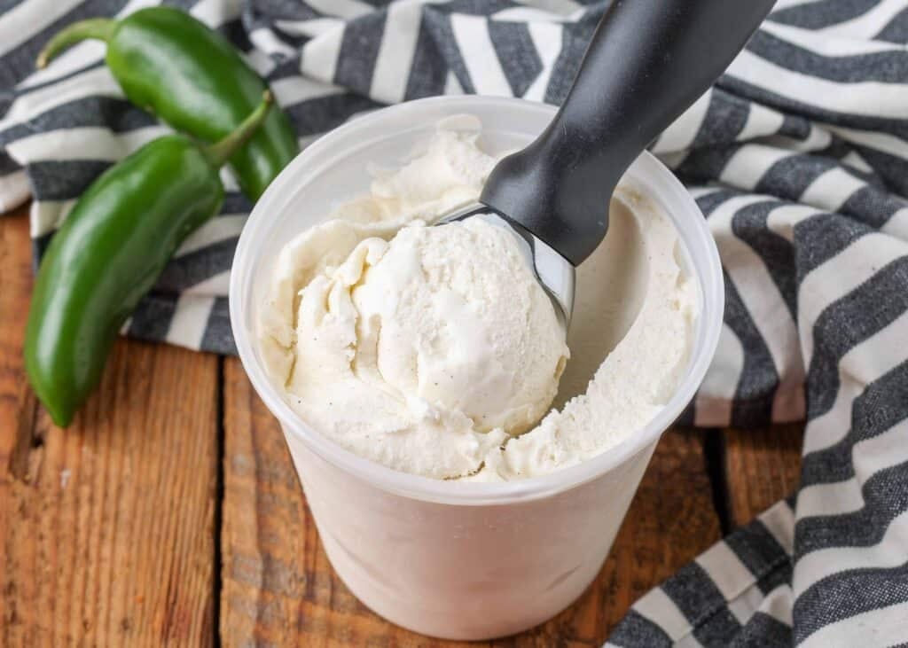 ice cream in a container next to jalapenos