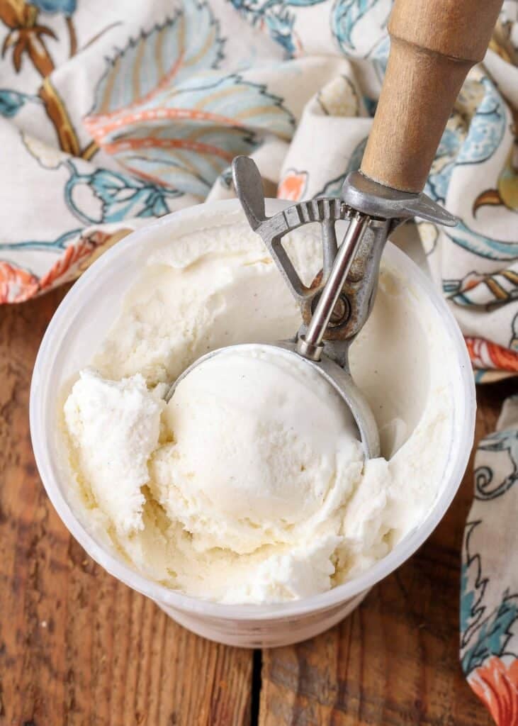 Philadelphia Style Ice Cream in freezer container with wooden scoop