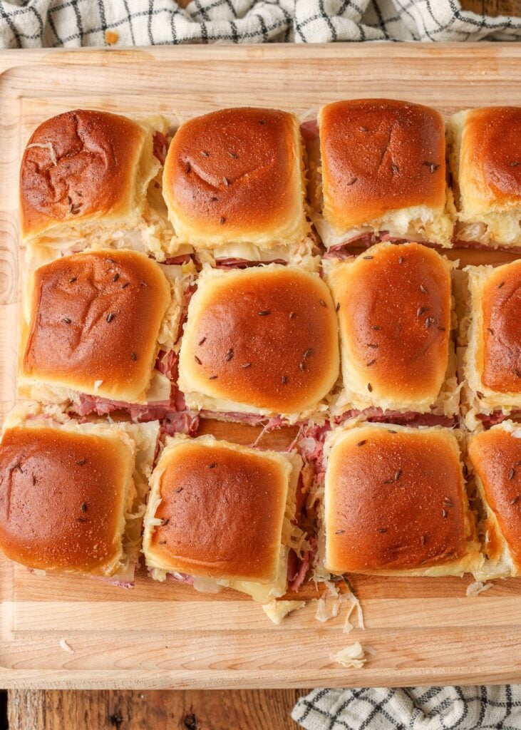 overhead shot of baked sliders on cutting board