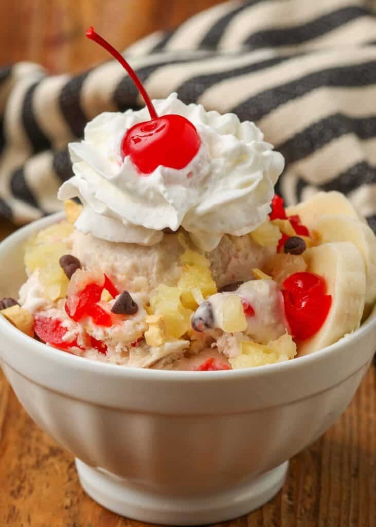 banana split ice cream with whipped cream and a cream on top
