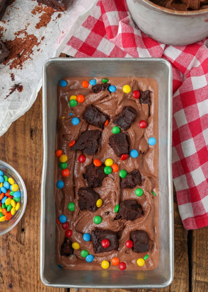 pan with chocolate ice cream, brownie chunks, and candies