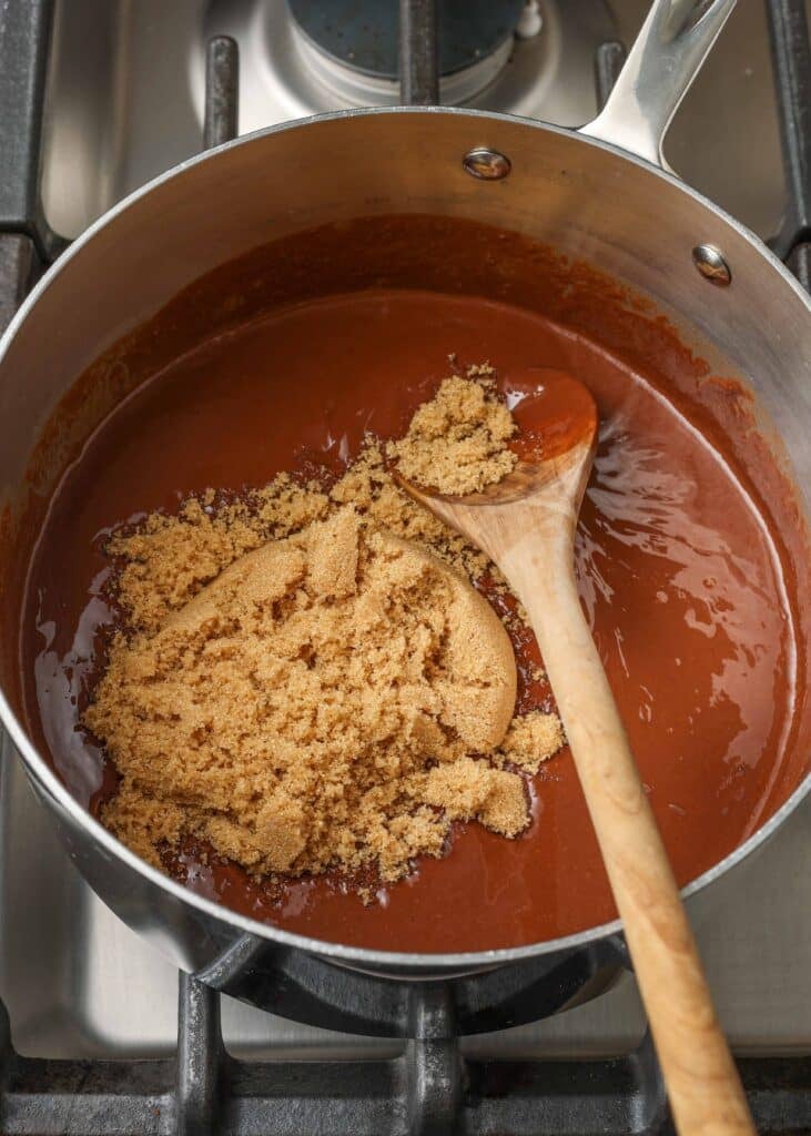 adding brown sugar to saucepan