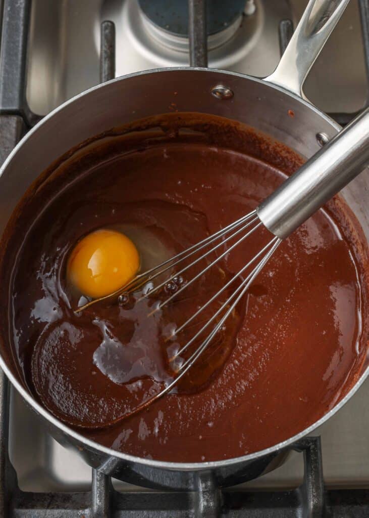 adding eggs to brownie mixture