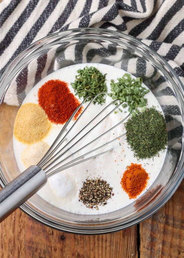 ranch dressing ingredients in bowl with whisk