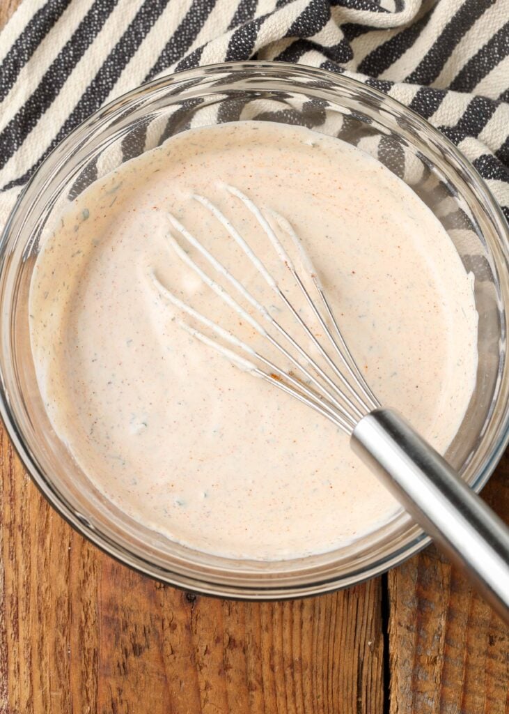 bowl of spicy ranch dip with whisk