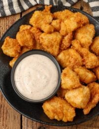 chicken chunks on black plate with bowl of blackened ranch dip
