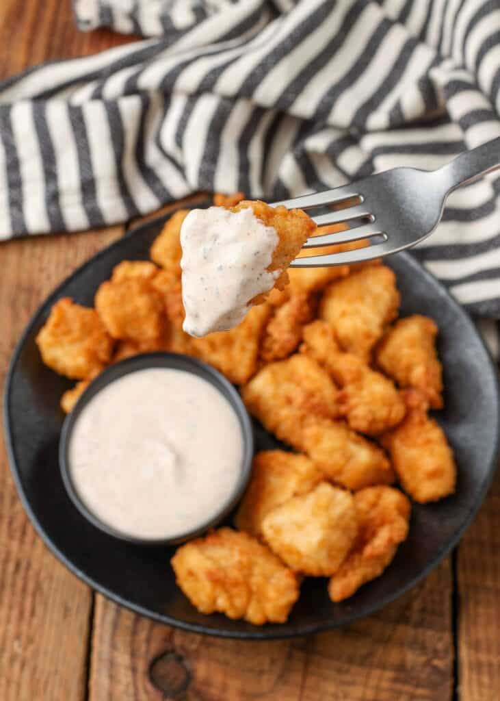 chicken chunk dunked in ranch dip on fork