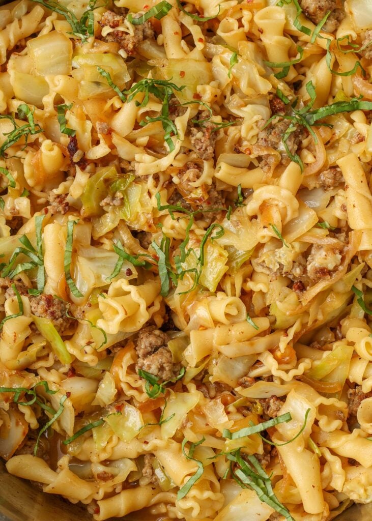 close up of sausage pasta with cabbage