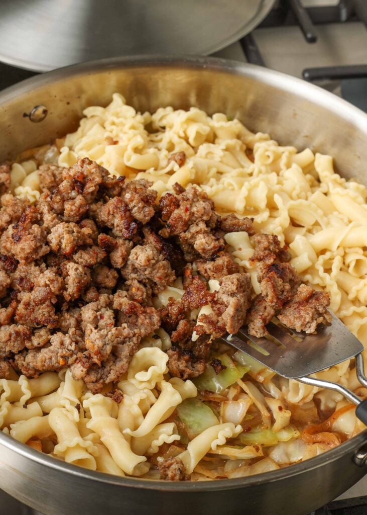 pasta and sausage in large skillet