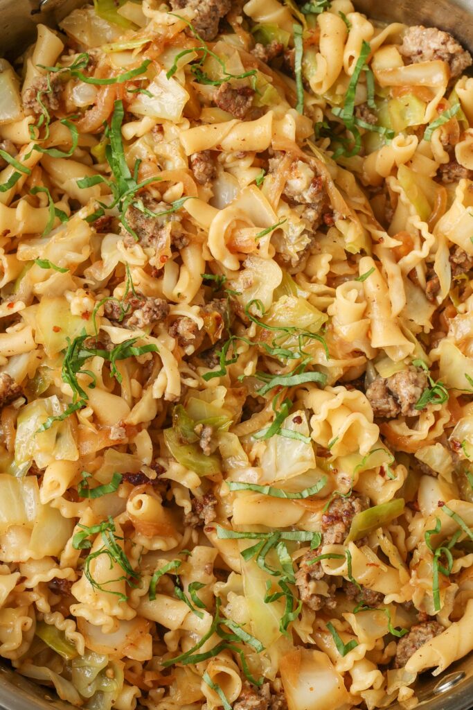 close up of pasta with cabbage and sausage