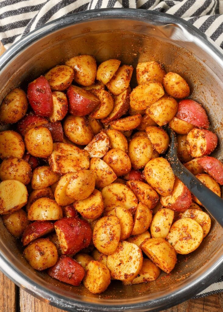 potatoes tossed in oil and spices before roasting