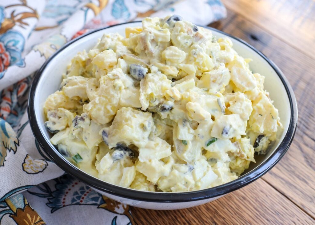 Classic Potato Salad with plenty of eggs, pickles, and olives.