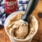 ice cream scoop in container of ice cream next to dr pepper bottle