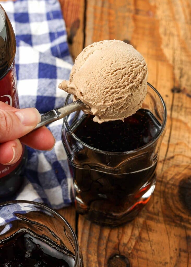 scoop of ice cream being dropped into glass of dr pepper